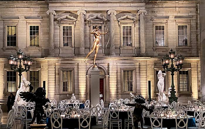 A golden statue rises above a cluster of dining tables