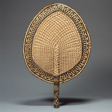 A leaf shaped embroidered fan with a wooden handle