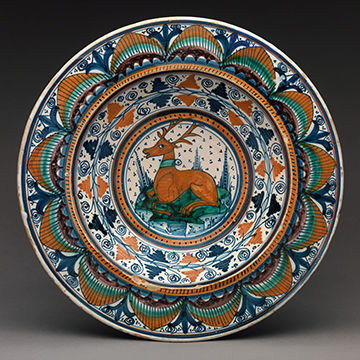 Valencian lusterware plate with stag resting in orange, red, green, blue, and white 