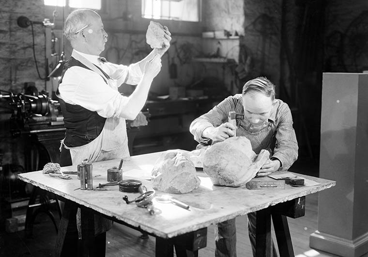 Conservators restoring ceramics in a workshop