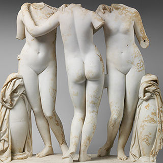 Marble statue of three Graces linked in a dance-like pose