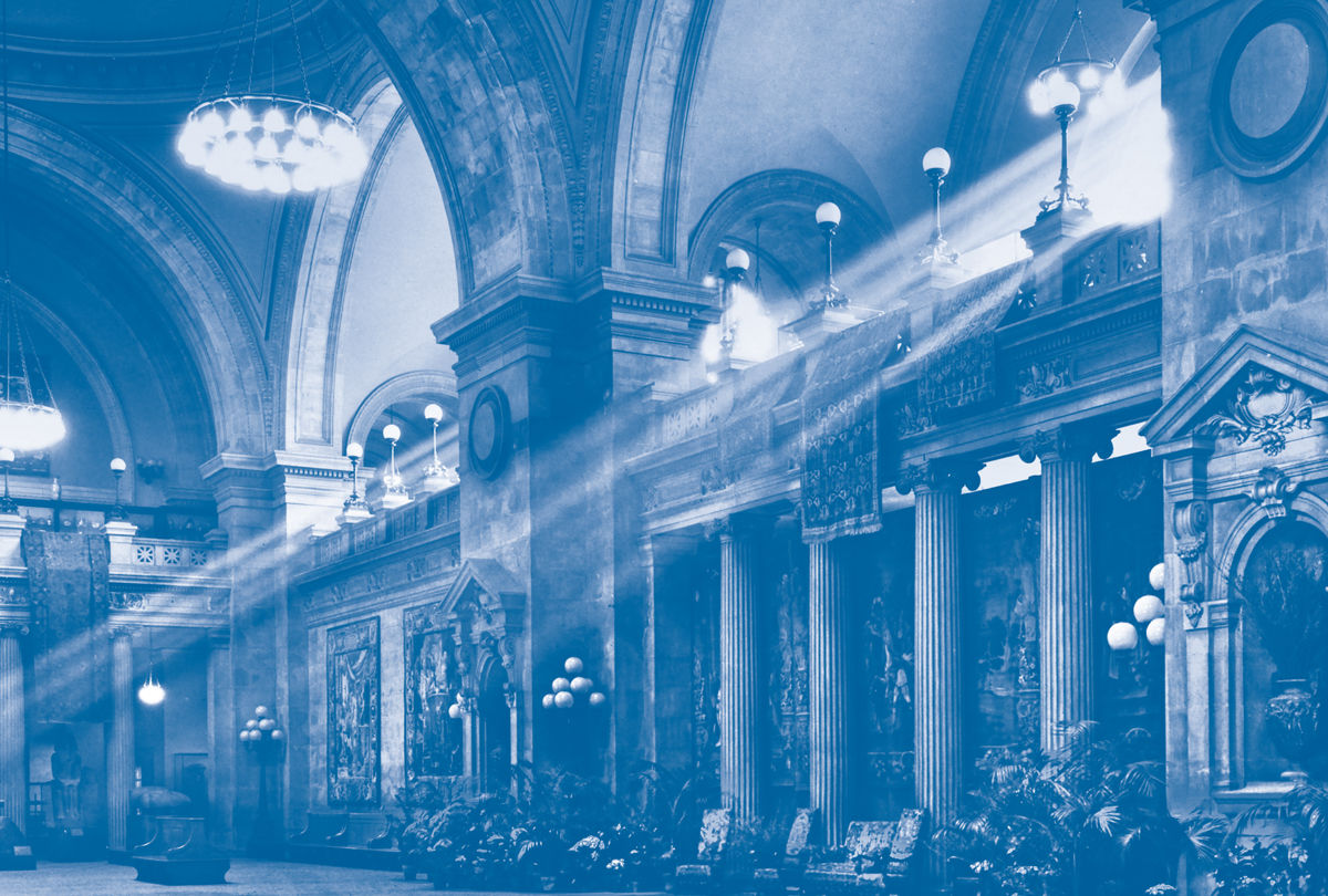 Photograph of The Met's Great Hall in blue tones with raking sunlight