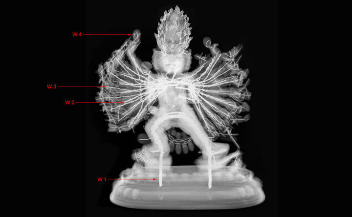  X-ray radiograph of a statuette of Vajrabhairava with arrows indicating four different wire thicknesses