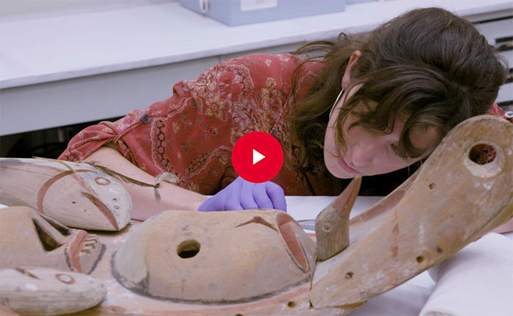 Objects conservator working on an indigenous wooden Yu'pik mask