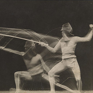 Long-exposure black-and-white image of a fencer in combat
